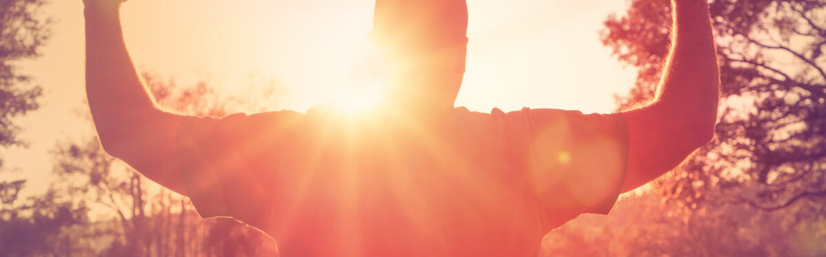 Man Arms Up Sunbeams shutterstock 243832807